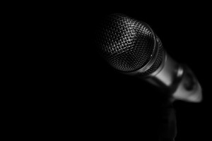 Microphone on a black background.